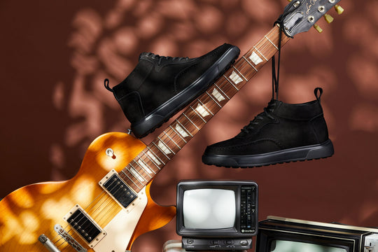Black lace-up sneaker boots with moc-toe stitching and low-profile sole