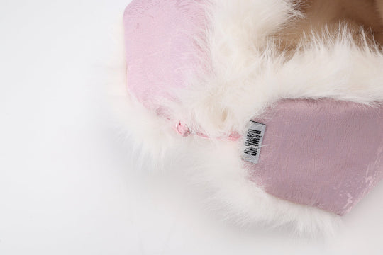 Pale pink lining with faux-fur trim and small tag near the side seam