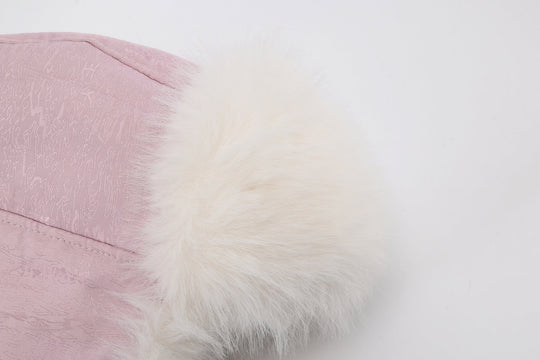 Reversible fur trapper hat detail: pink fabric with fluffy white faux-fur edge