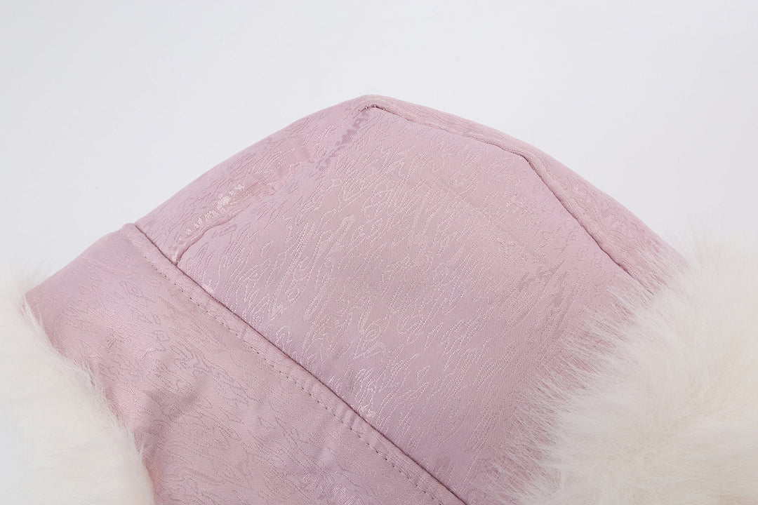 Reversible fur trapper hat in pink with white faux-fur trim along top seam