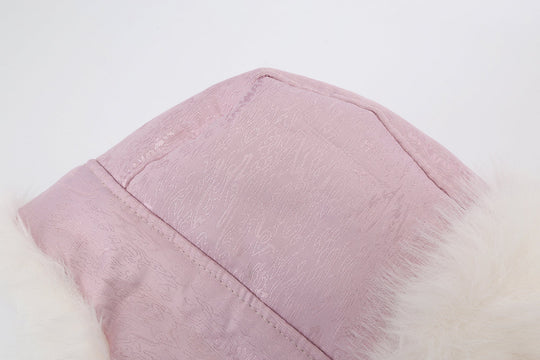 Reversible fur trapper hat in pink with white faux-fur trim along top seam