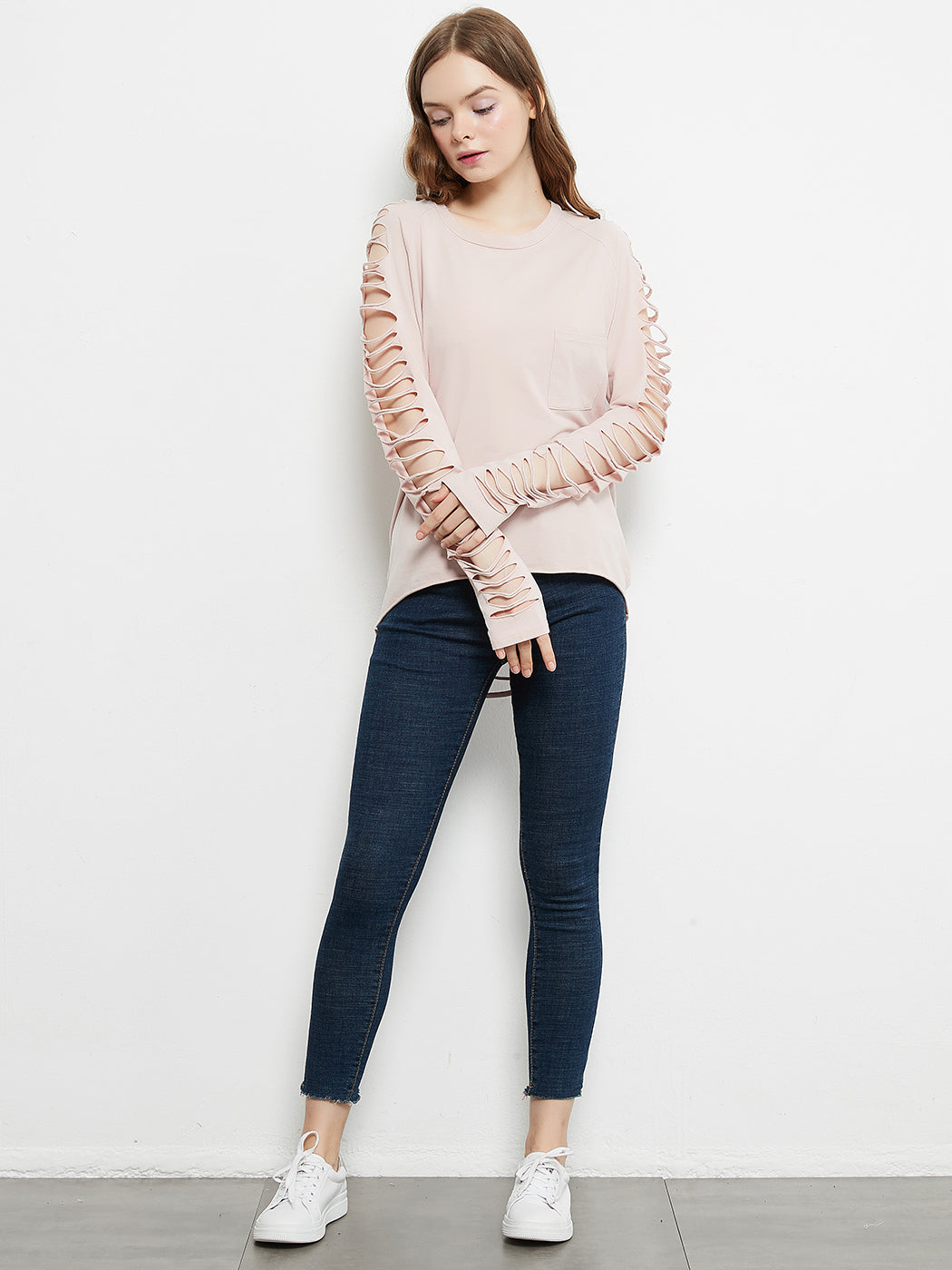 Light pink long-sleeve pullover with lace-up sleeve cutouts and front chest pocket