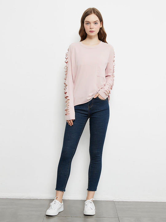 Light pink long-sleeve pullover with lace-up sleeve cutouts and hip-length hem