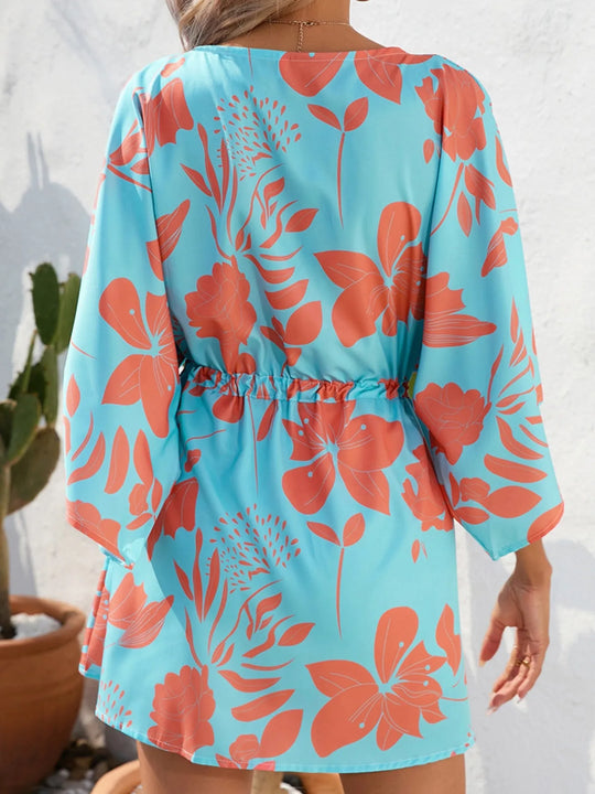 Back view of sky-blue floral button-up dress with drawstring waist and long sleeves