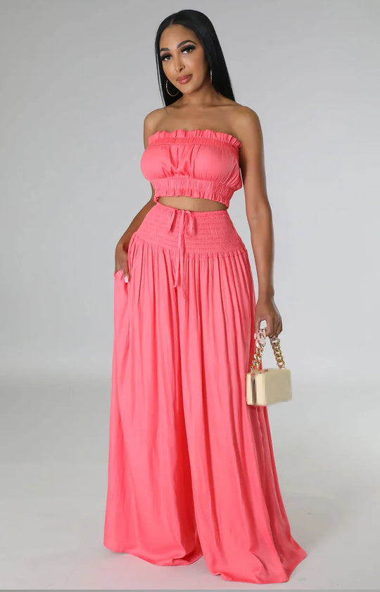 Women’s two-piece outfit in coral: off-shoulder crop top and flowy tiered maxi skirt