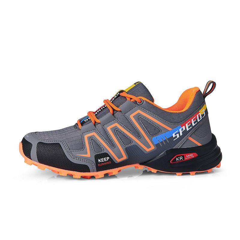 Men's off-road running shoe in dark gray with orange accents and rugged tread.