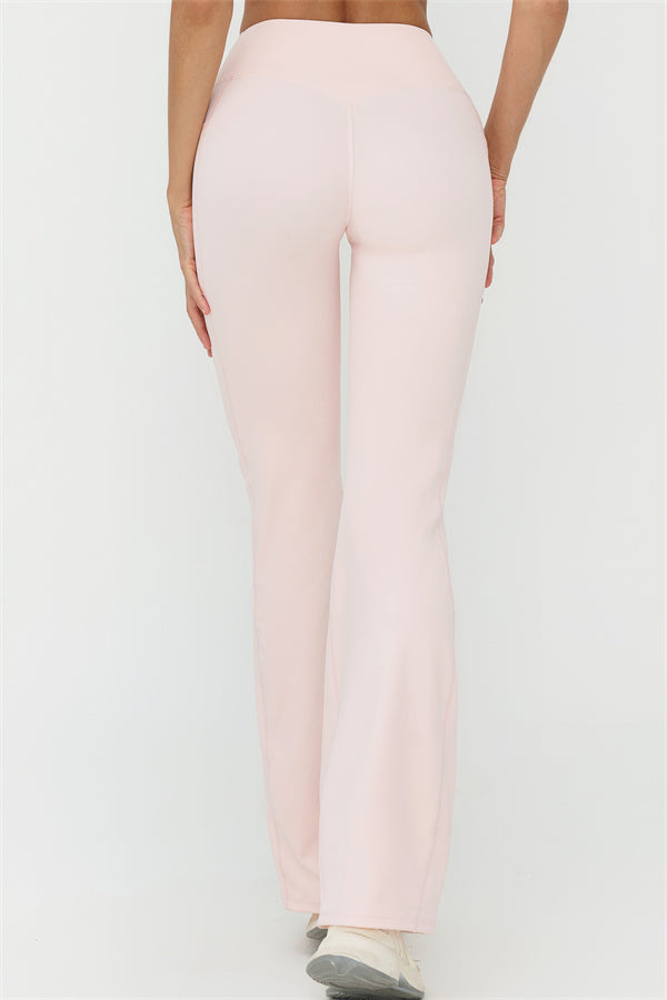 Light pink flared-leg pants with long straight silhouette and subtle panel seams, full length