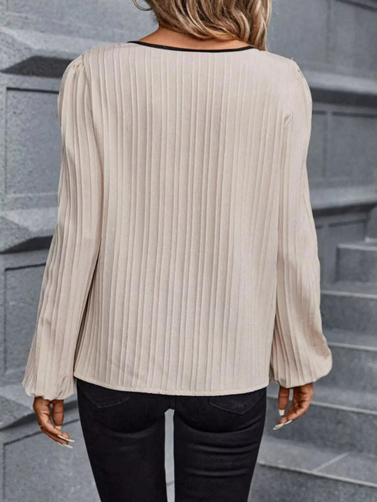 Cream textured blouse back view, long sleeves with gathered, ruffled cuffs