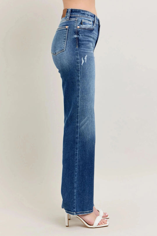 Side profile of high-waist straight-leg jeans with worn whisker marks, medium blue wash