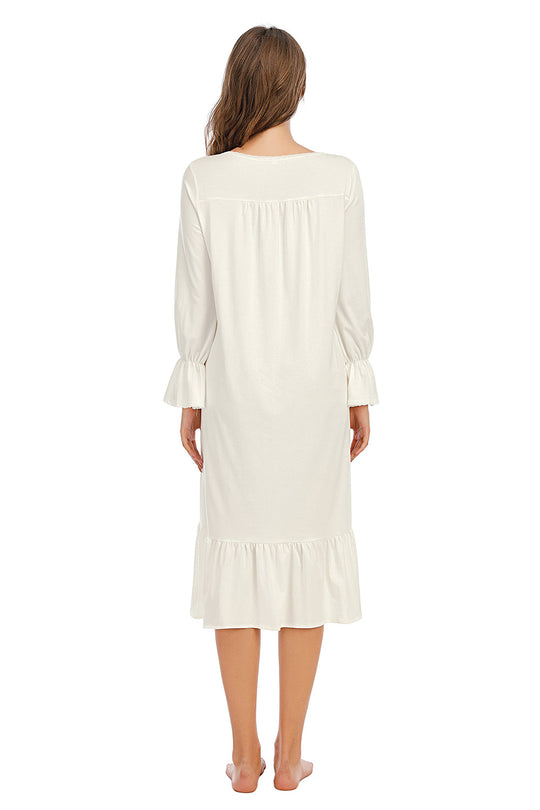 Back view: white nightdress with long gathered sleeves and ruffled hem
