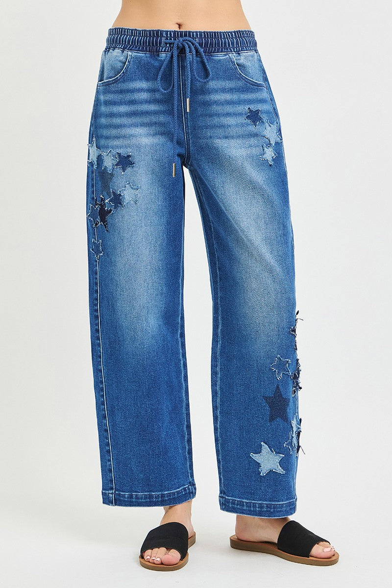 Slouchy cropped barrel jeans with elastic waist, drawstring, star patches, dark denim