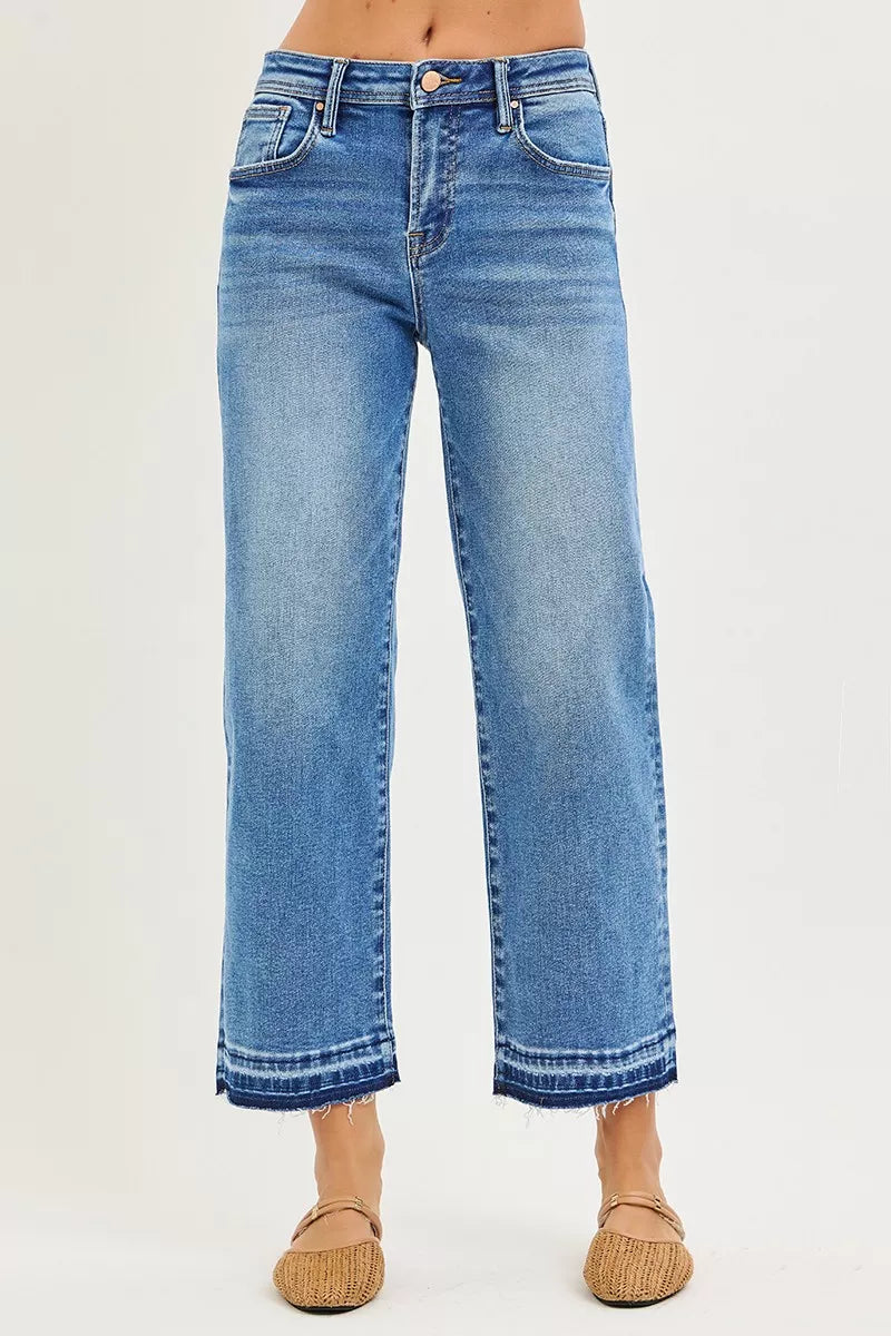 Medium-wash slouchy boyfriend jeans, relaxed straight legs, frayed cuffed hem