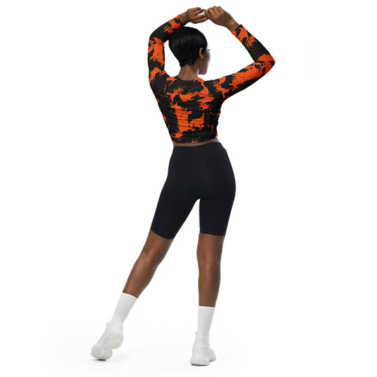 Back view: black and orange paint splatter long-sleeve fitted crop top
