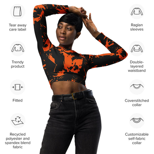 Fitted raglan long-sleeve crop top in black with orange paint-splatter graphic