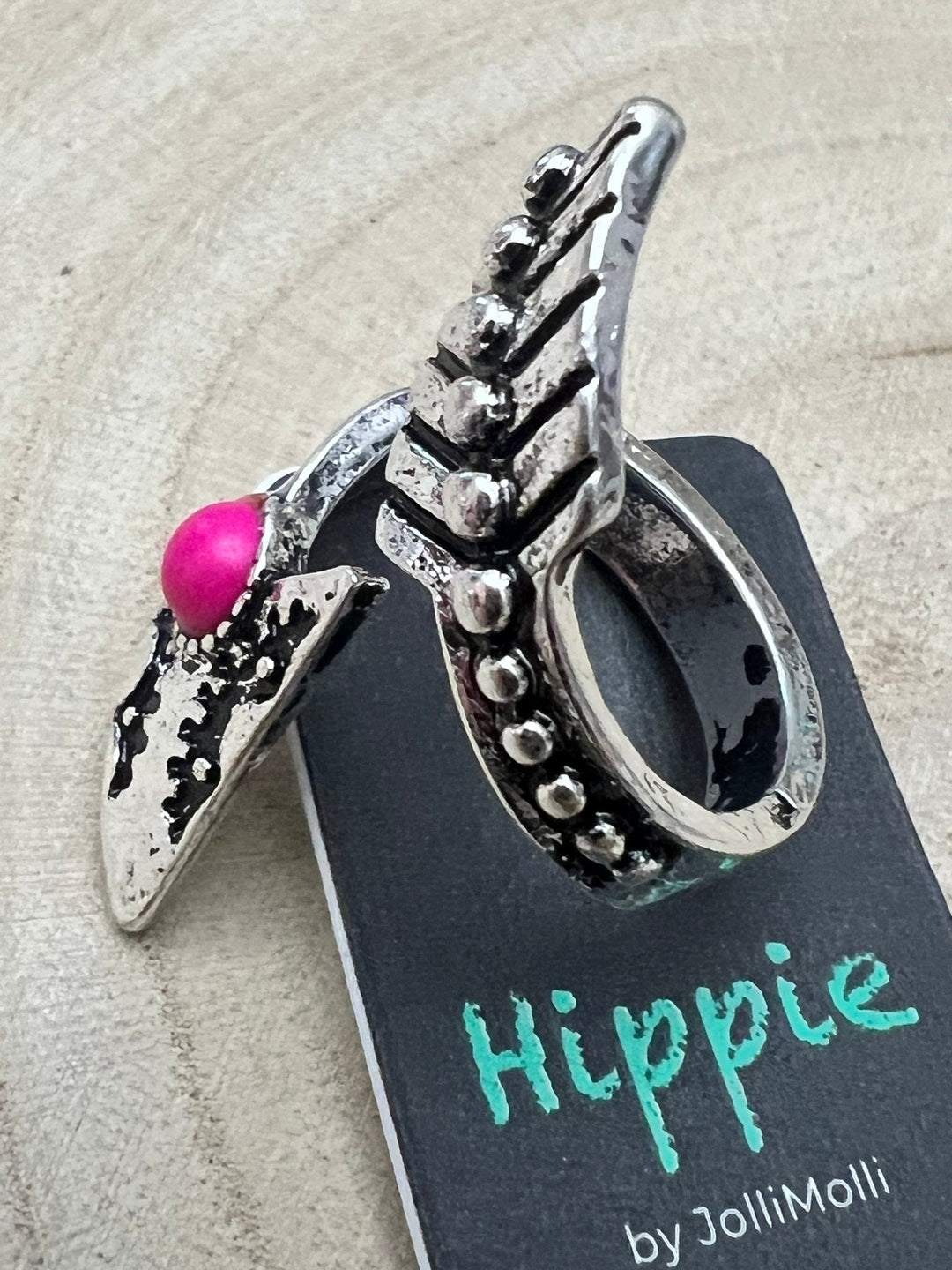Arrowhead cuff ring with pink faux stone and scalloped silver metal setting