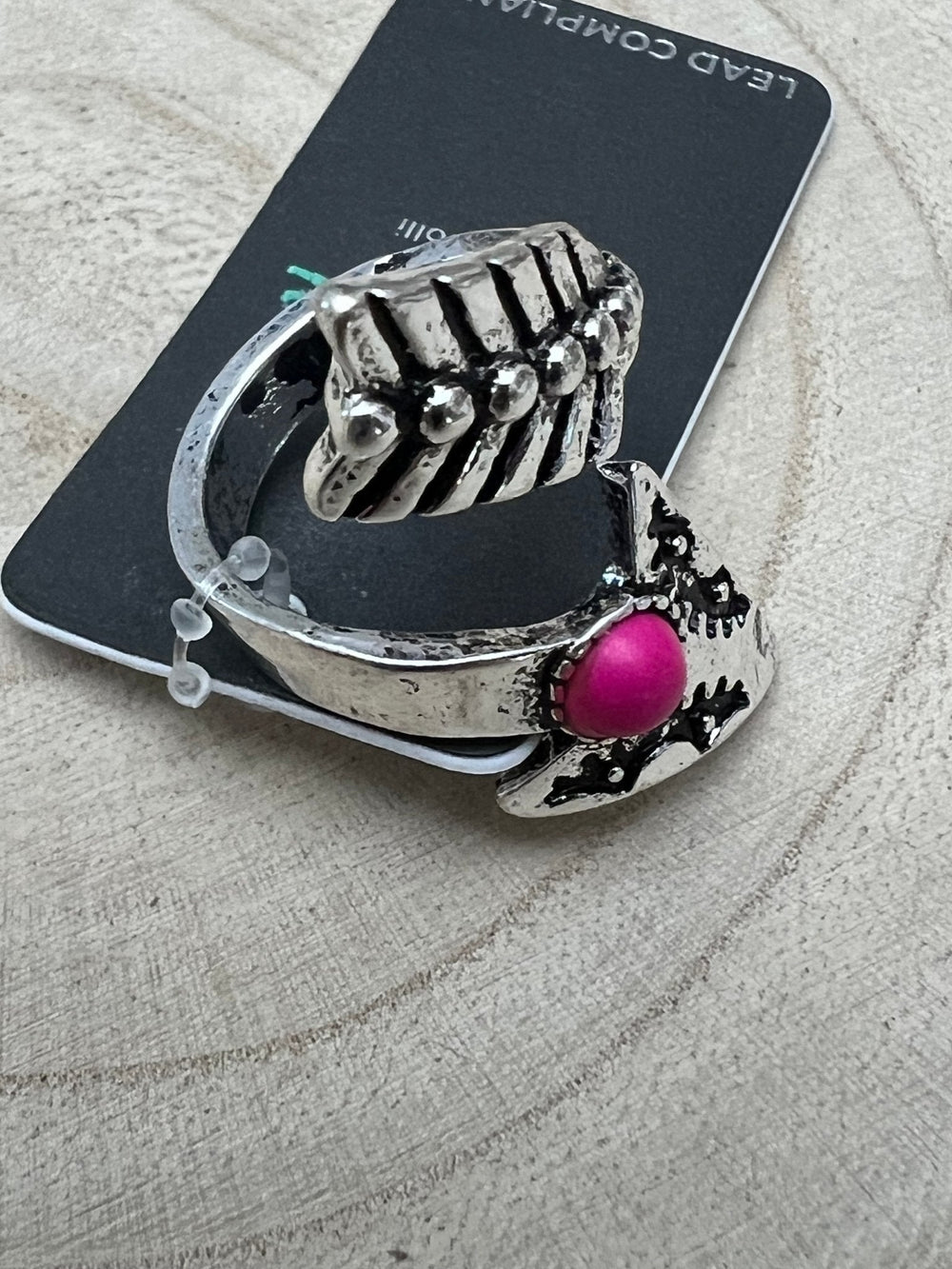 Silver-tone arrowhead cuff ring with bright pink faux stone on side