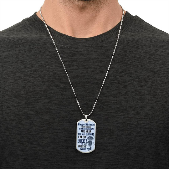 Happy Birthday dog tag necklace on a silver chain worn on a man’s chest