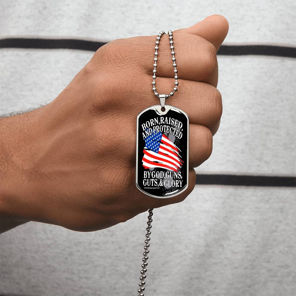 Patriotic silver dog tag necklace held in hand on beaded chain