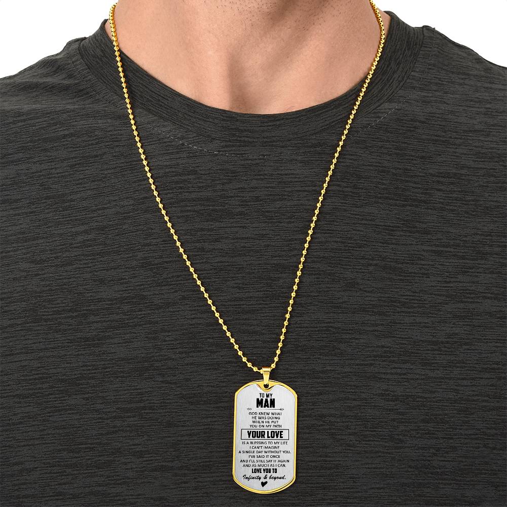 Gold dog tag necklace worn on chest, engraved pendant on chain
