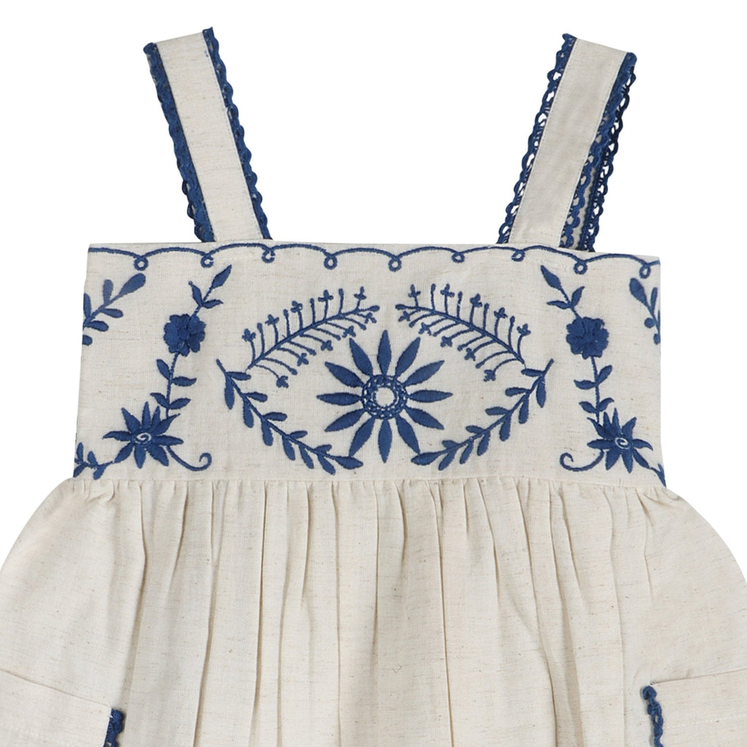 Embroidered linen dress bodice with blue floral motif, ruffled smocking, and two shoulder straps