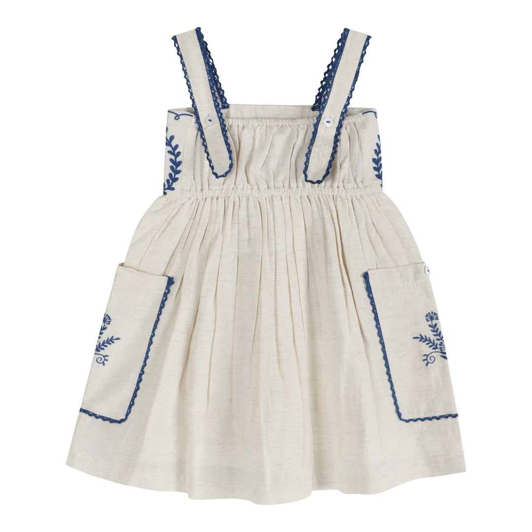 Linen dress with gathered square neckline, blue embroidery trim, and pocket detailing on skirt