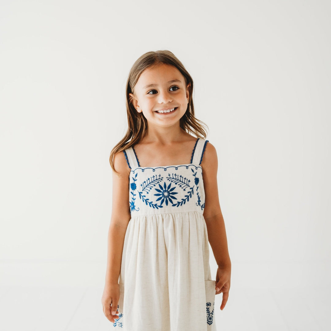 Sleeveless linen dress with blue floral embroidery at chest and vertical panel stitching