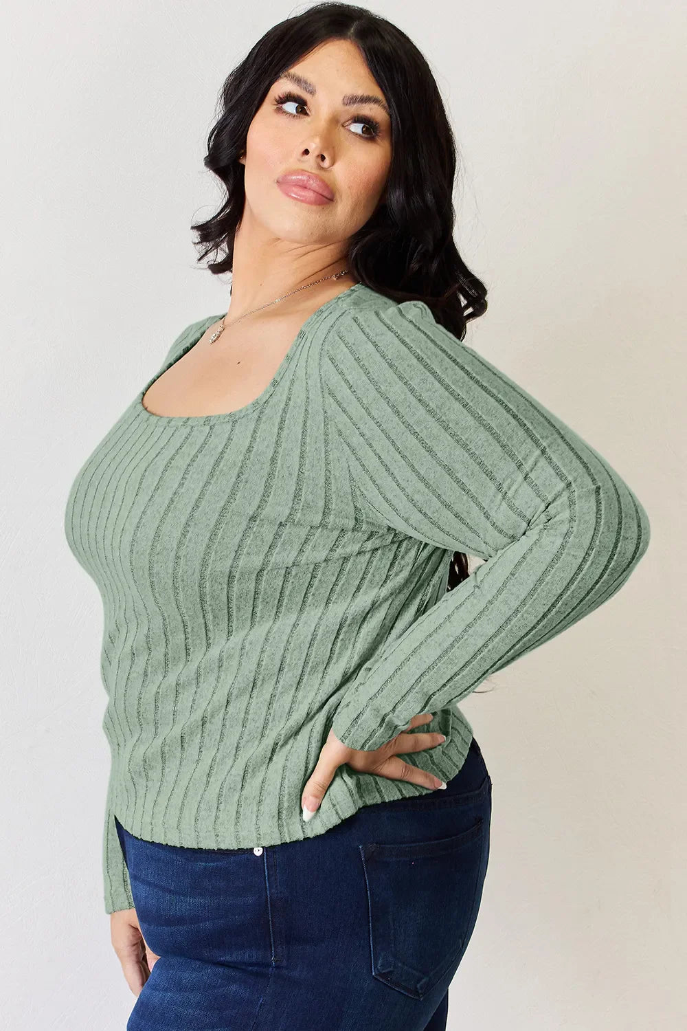 Light green ribbed long-sleeve T-shirt with scoop neck, hand at hip