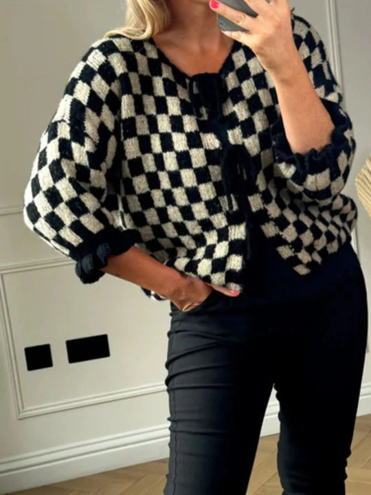 Black checkered tie-front knit cardigan with tie neckline and textured ribbed sleeve cuffs.