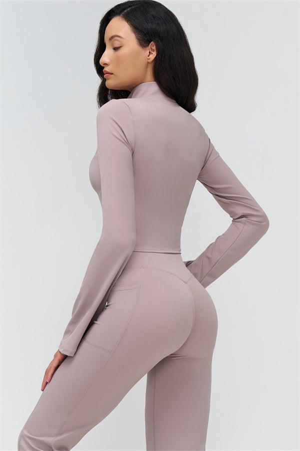 Back view of mauve flared leggings and fitted long-sleeve zip jacket