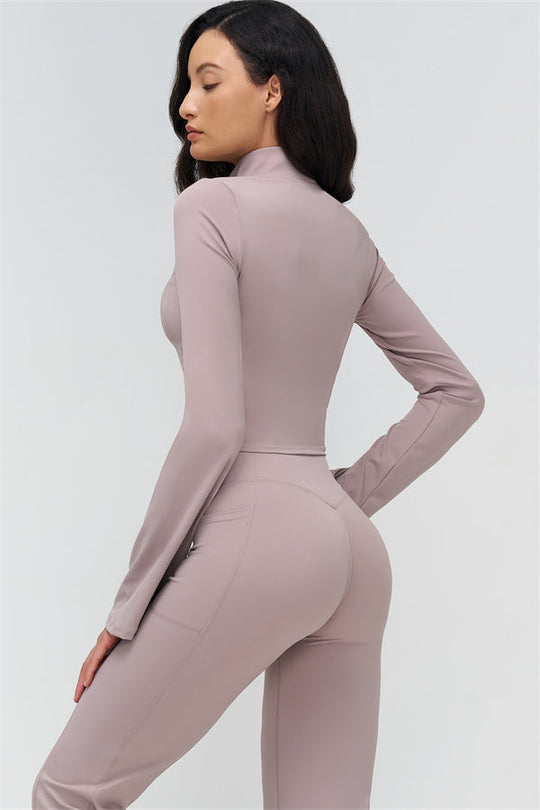 Back view of mauve flared leggings and fitted long-sleeve zip jacket