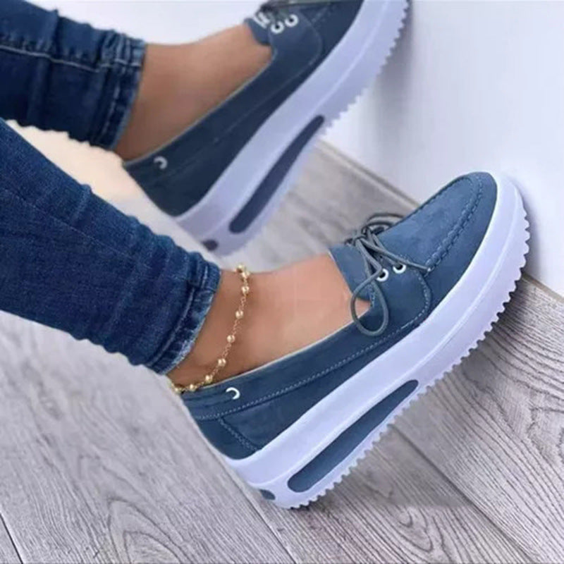 Blue lace-up platform loafers with chunky white sole and thick raised heel