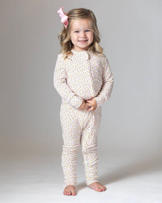 Bamboo romper pajamas, white with multicolor confetti dots, front view on child