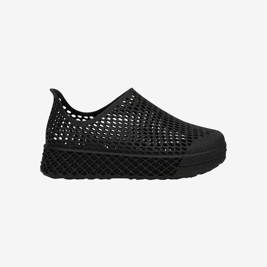 Black 3D printed kids slip-on shoe with perforated mesh upper and thick rubber sole