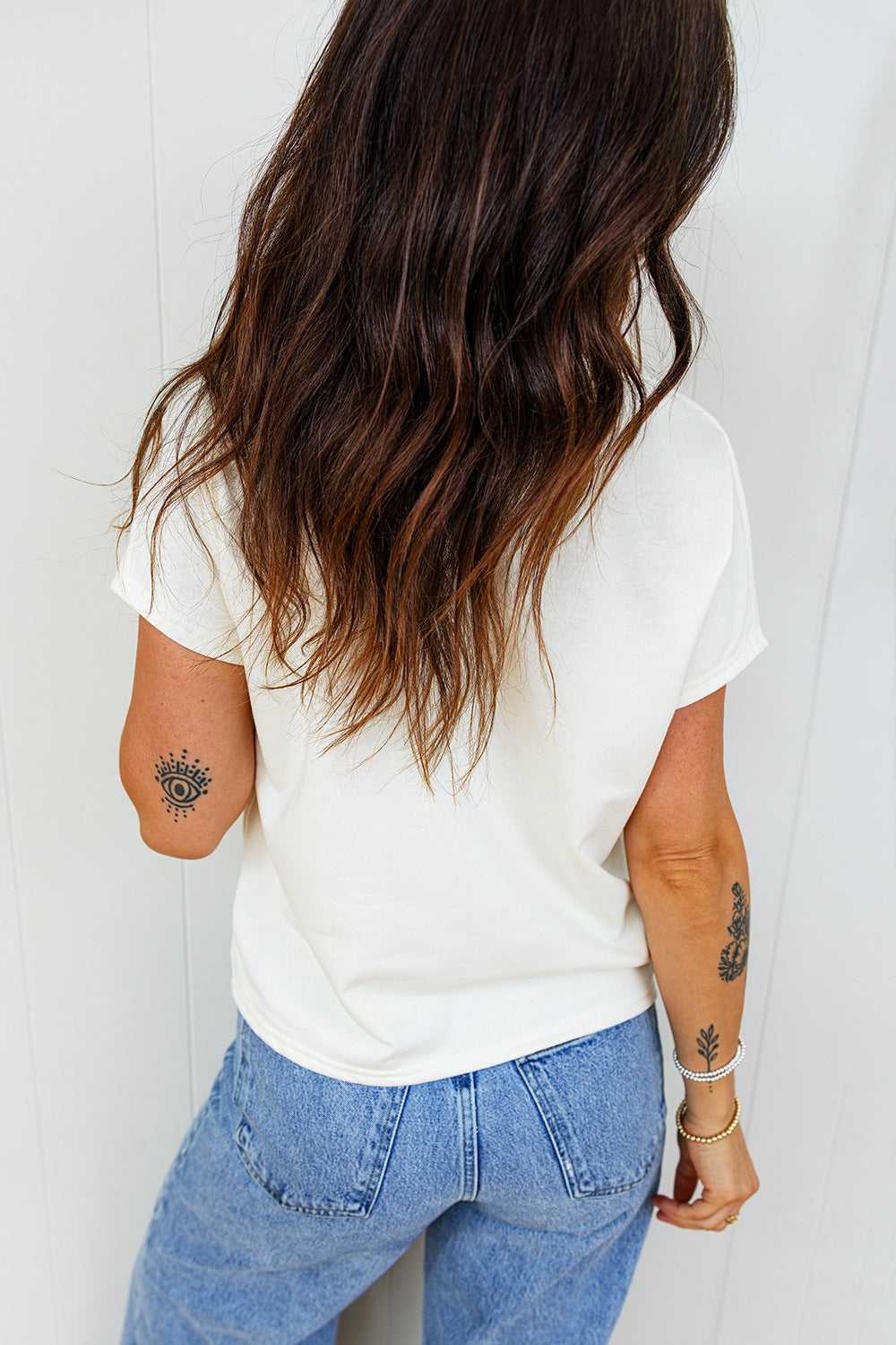 Back view of white relaxed fit T-shirt, plain fabric