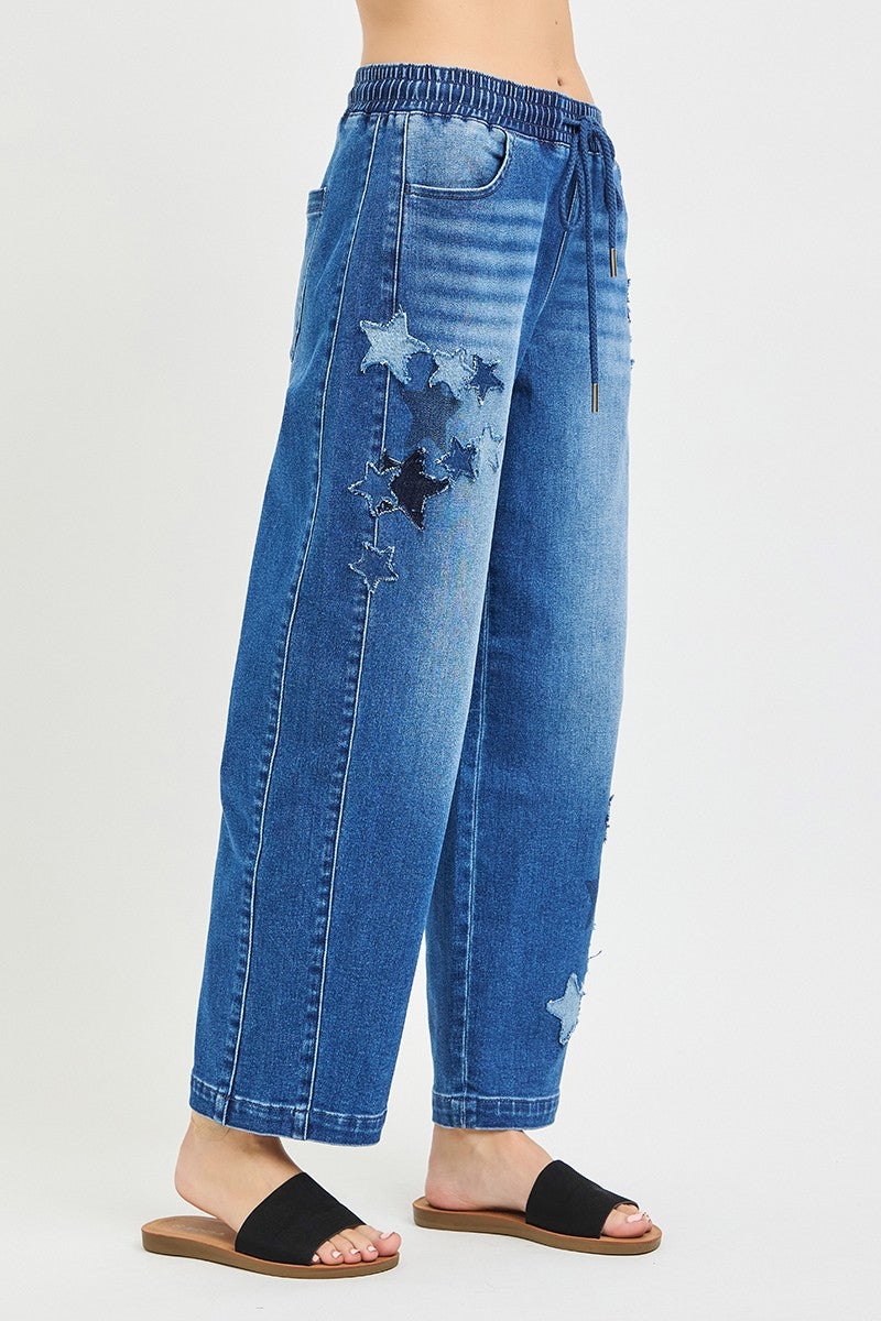 Back view slouchy cropped barrel jeans, elastic waistband, dark denim, star patches