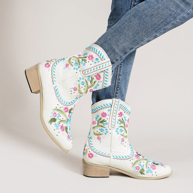 White mid-tube boots with colorful floral embroidery and blue scalloped edge trim