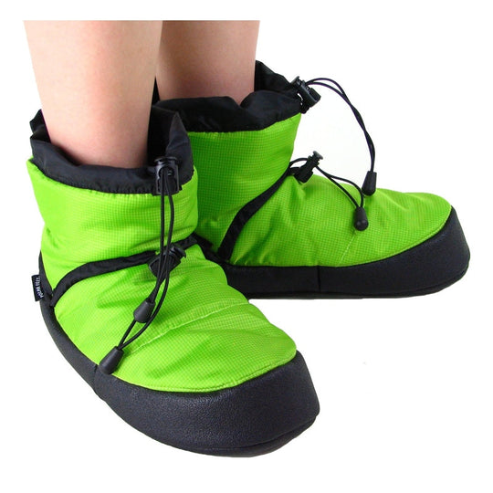 Lime camp booties worn on feet, neon green uppers with black drawcord closures