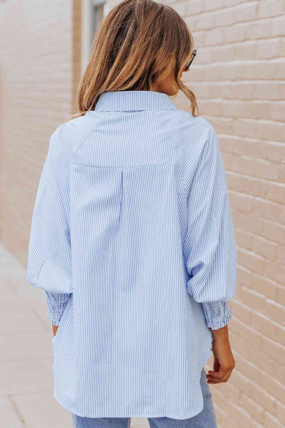 Pastel blue back view of lantern sleeve shirt with yoke and center pleat