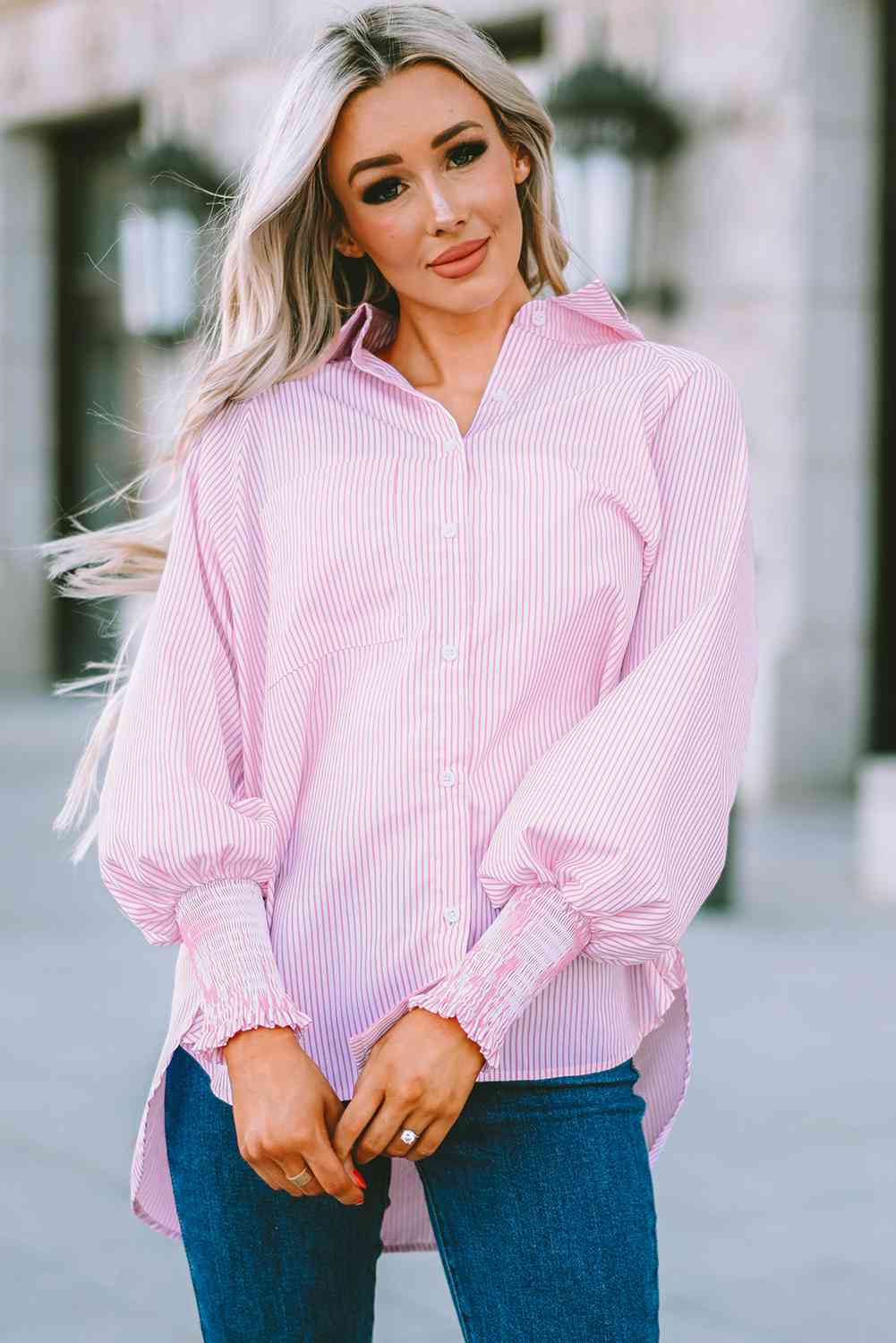 Blush pink striped button-up shirt with lantern sleeves and button placket
