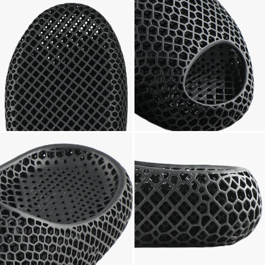 Black 3D-printed slipper close-up, perforated honeycomb texture and round toe opening
