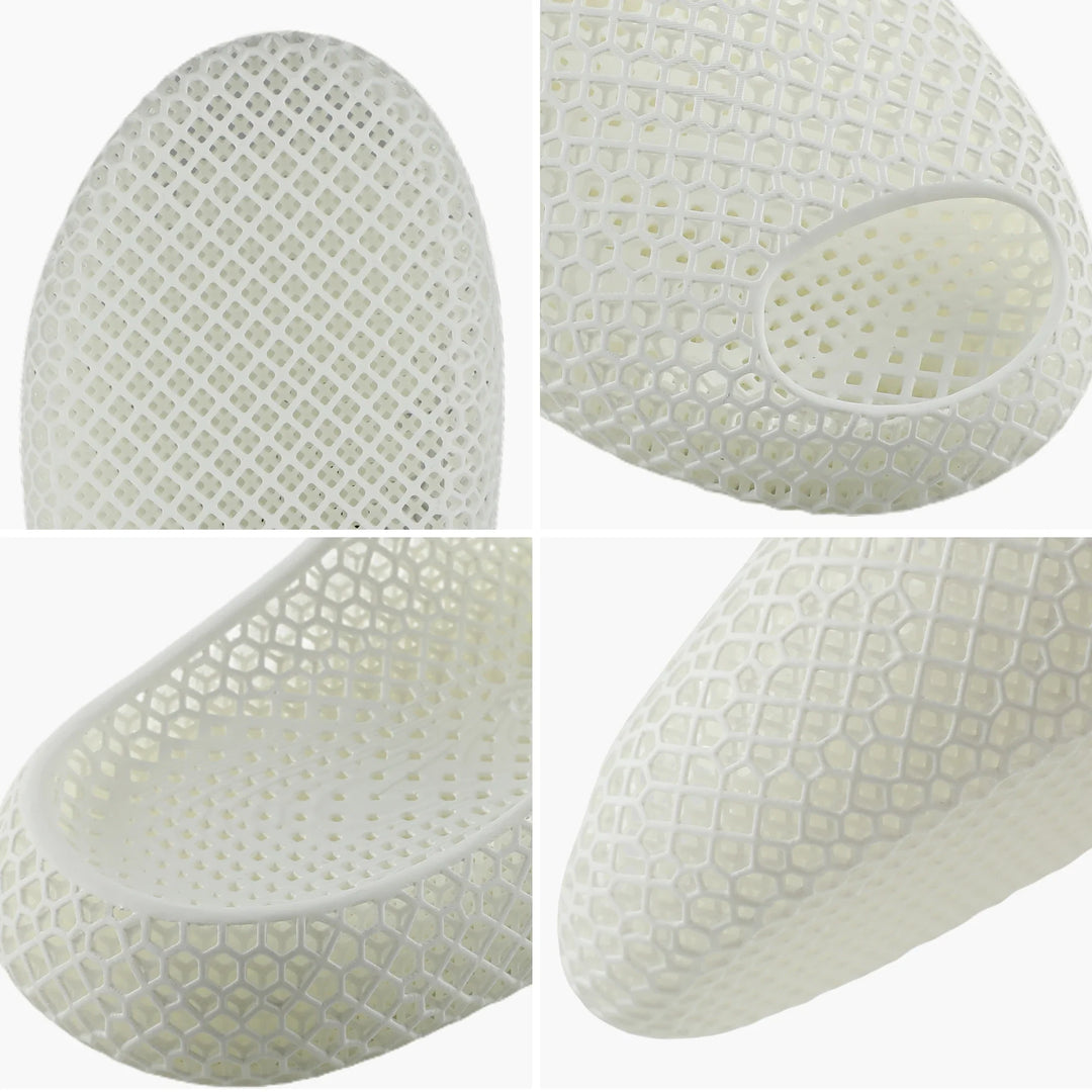 White 3D-printed slipper close-up, perforated honeycomb texture and oval toe cutout
