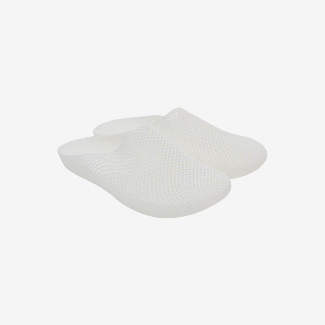 White 3D printed slippers with openwork grid texture, slip-on clog style, side view.