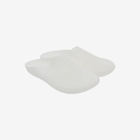 White 3D printed slippers with openwork grid texture, slip-on clog style, side view.