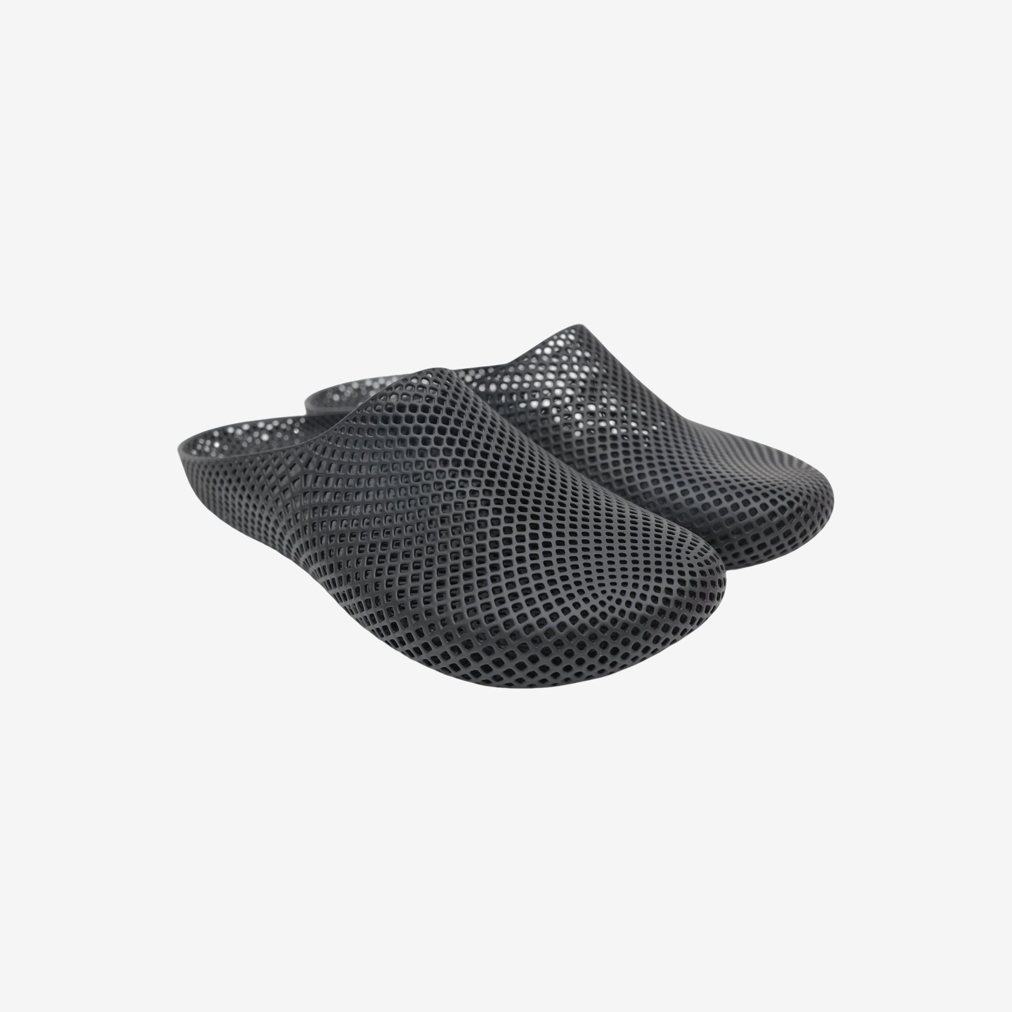 Black 3D printed slippers with openwork grid texture, slip-on clog style.