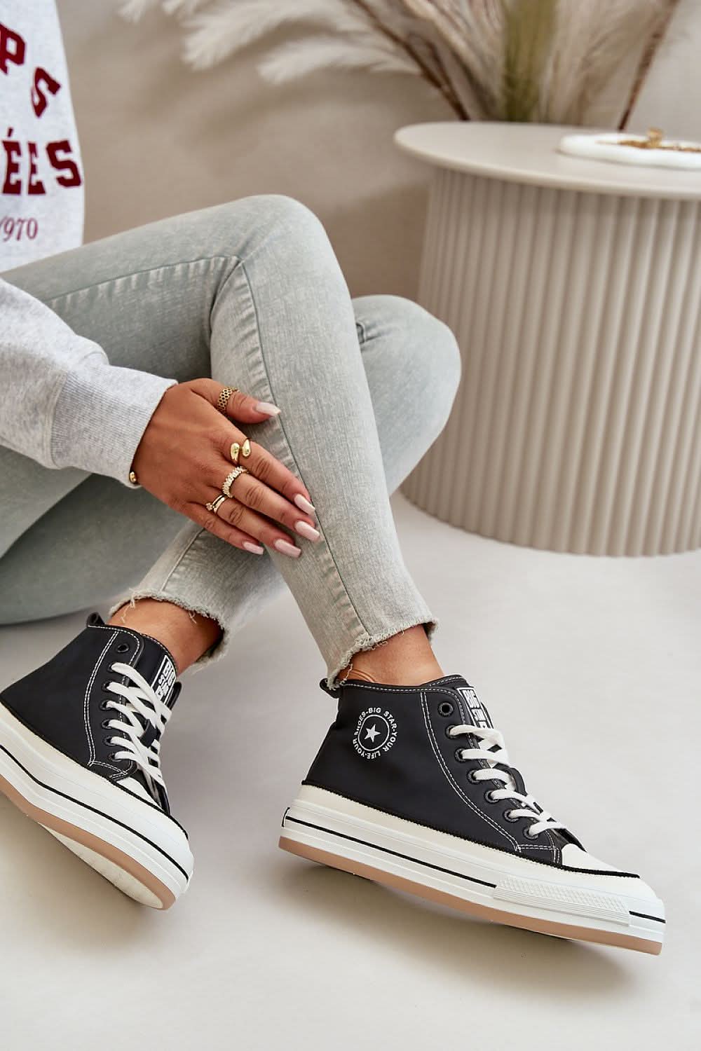 Black suede lace-up high-top sneakers with white stitching and platform sole.