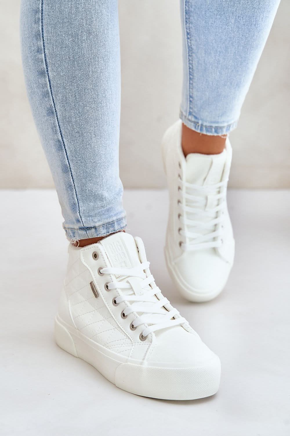 White high-top sneakers with quilted design, eyelets, and flat rubber sole