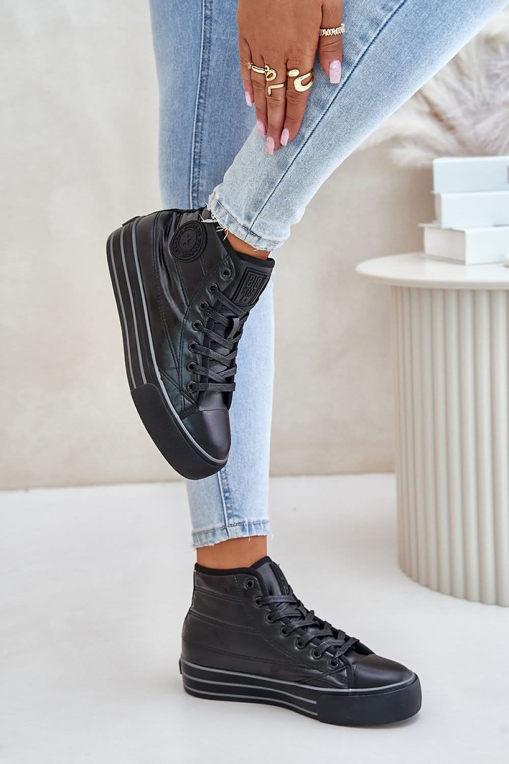 Black insulated platform sneakers with lace-up front and chunky sole