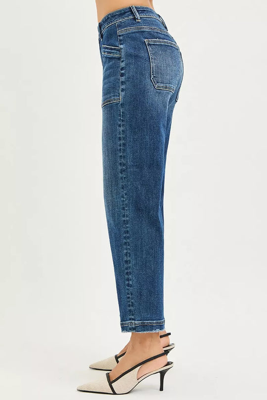 Dark blue baggy jeans side profile with stitched seams and cuffed hem