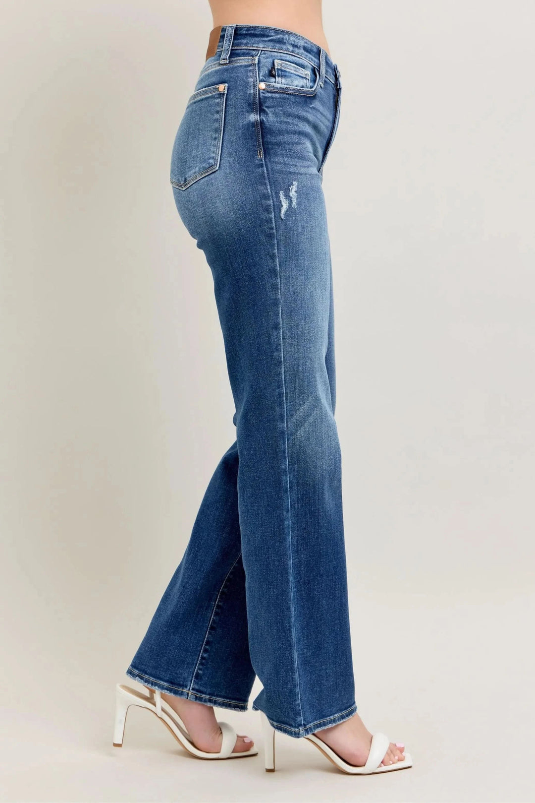 Side view of high-waist straight-leg jeans, medium blue wash with subtle fade and distressing