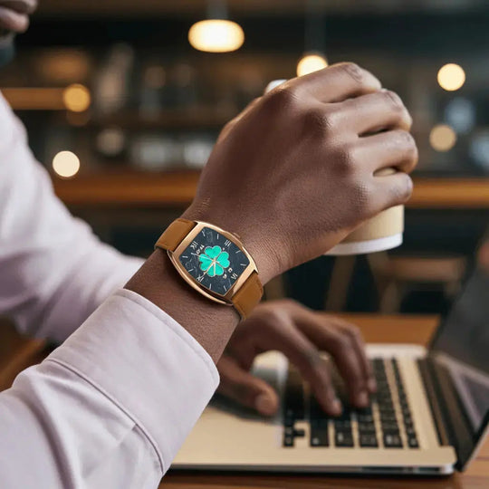 Mil-e smartwatch on wrist with tan leather band and green four-leaf clover face